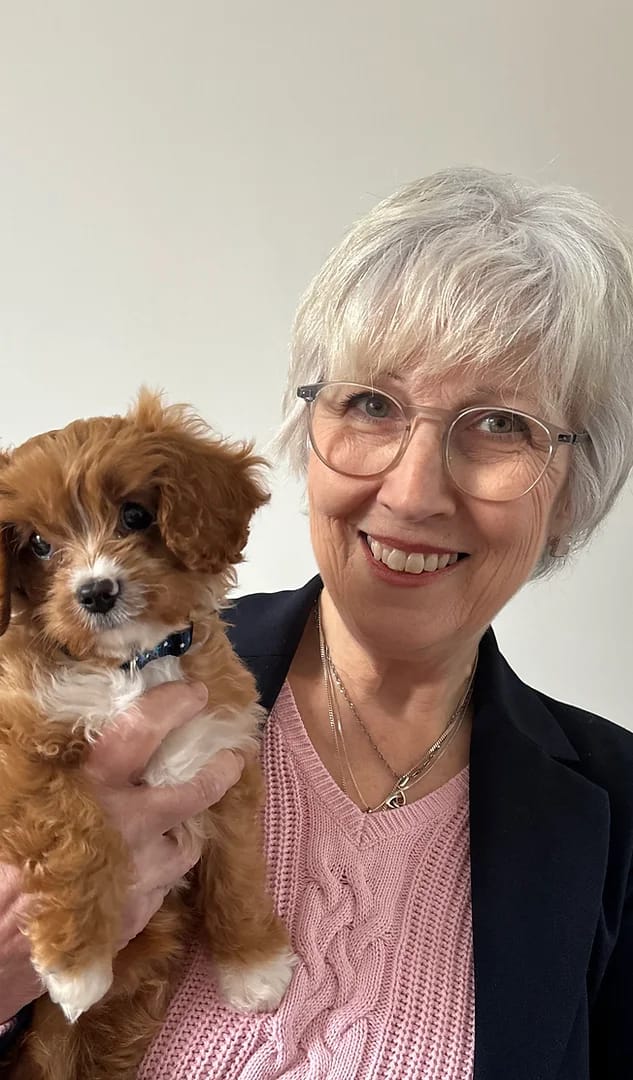 Martine Cullum Author holding her dog Dante as a dear fluffy puppy
